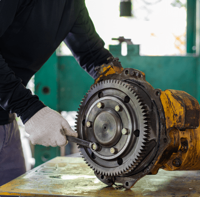 A man works on a large engine.