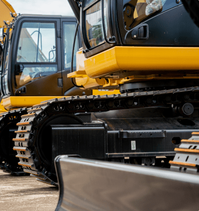 A row of yellow and black construction equipment.